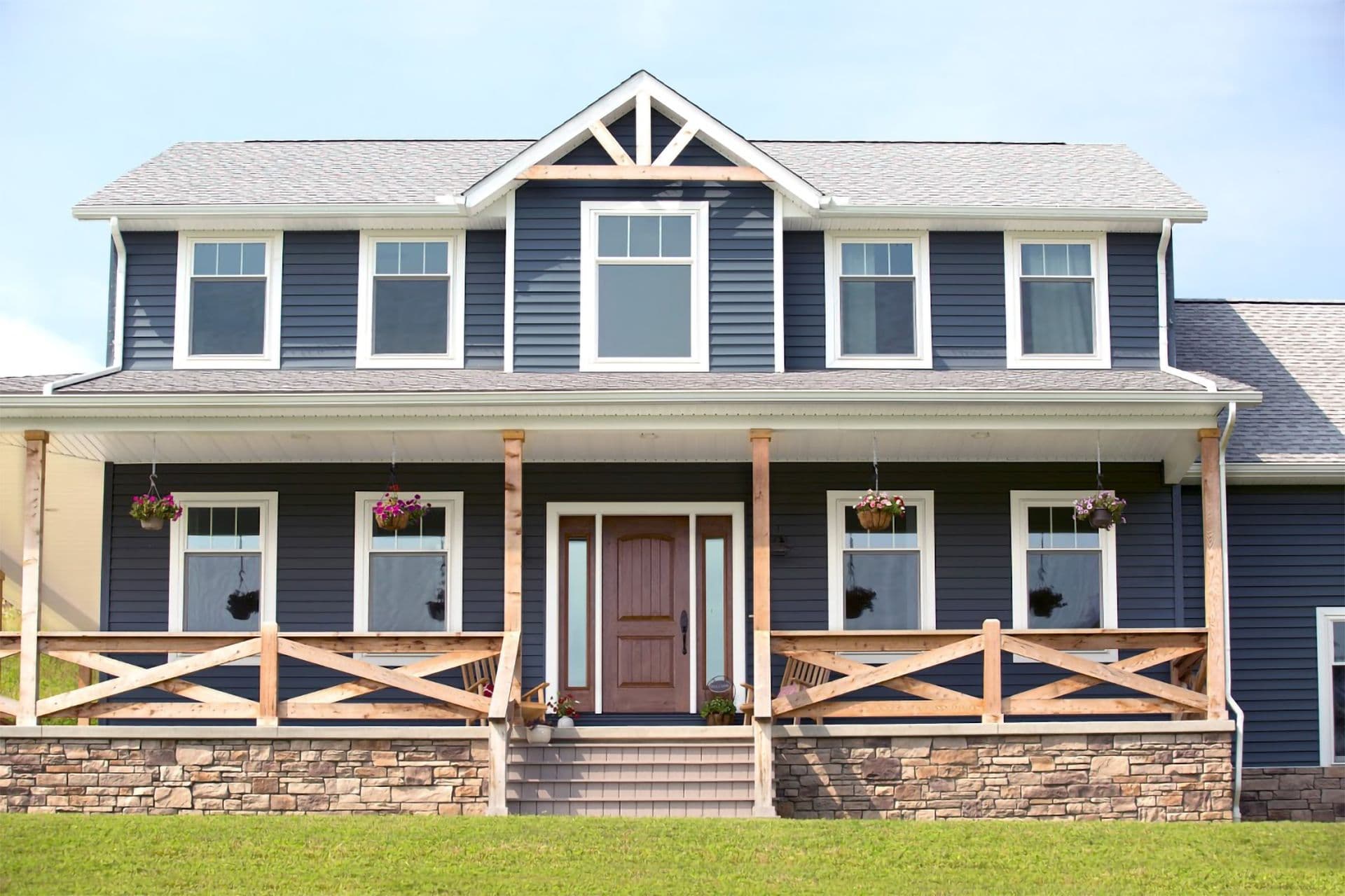 Blue house siding with porch and wooden fencing