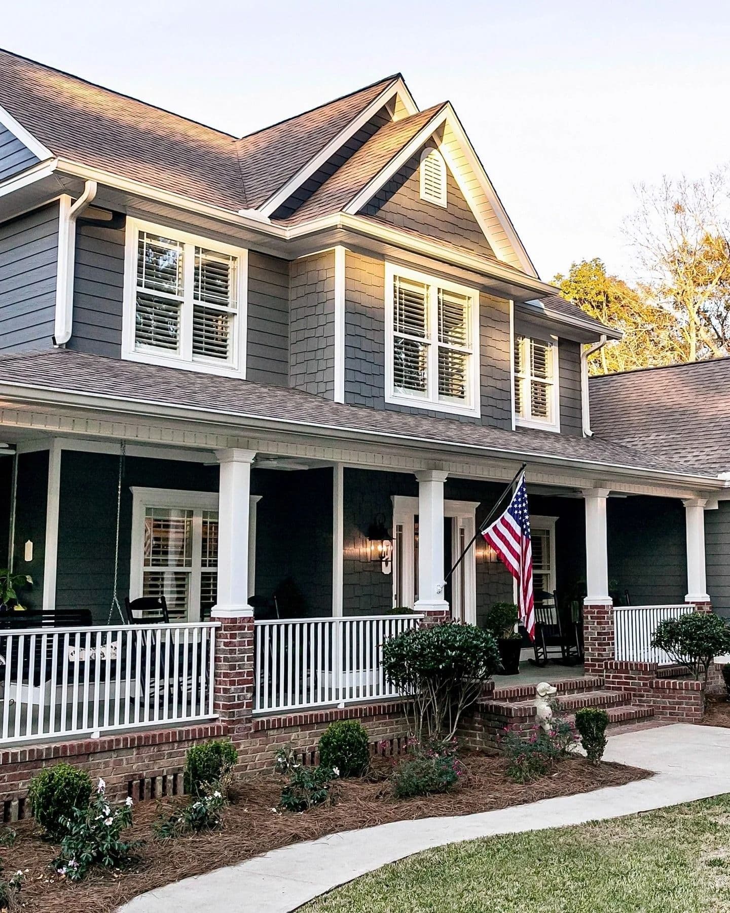 House with grey siding and american flag